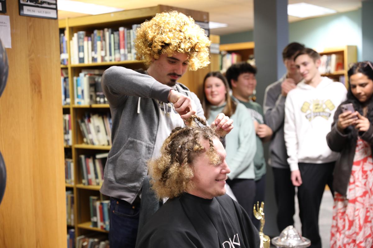 Mr. Starkweather getting his head shaved