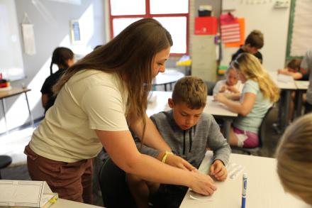 Mrs. Fox helps one of her 4th grade students with a STEM class project